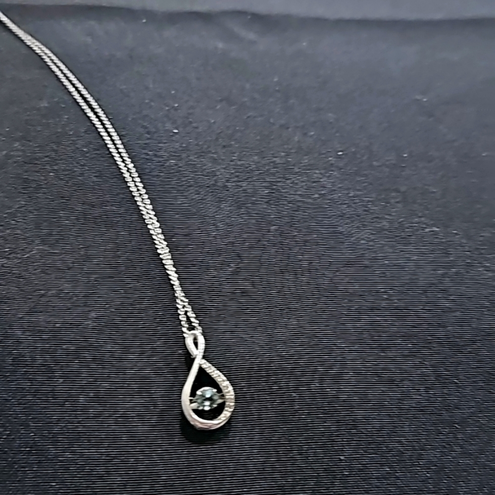 Sterling silver necklace and pendant with blue topaz stone.